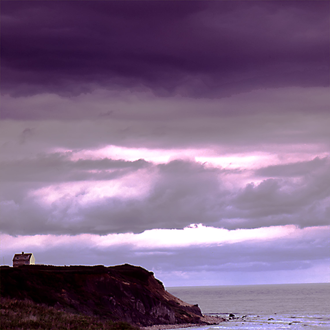 block island house on hill with storm clouds blue