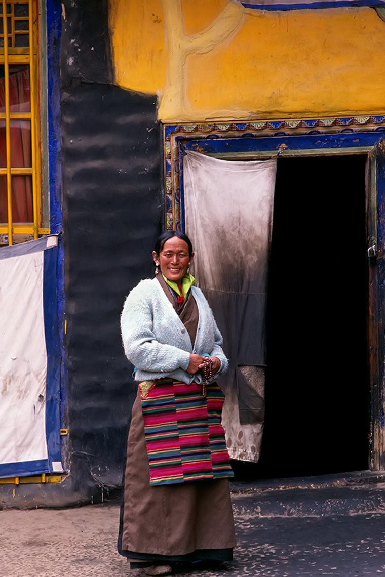 lhasa tibet woman yellow wall blue trim fabric