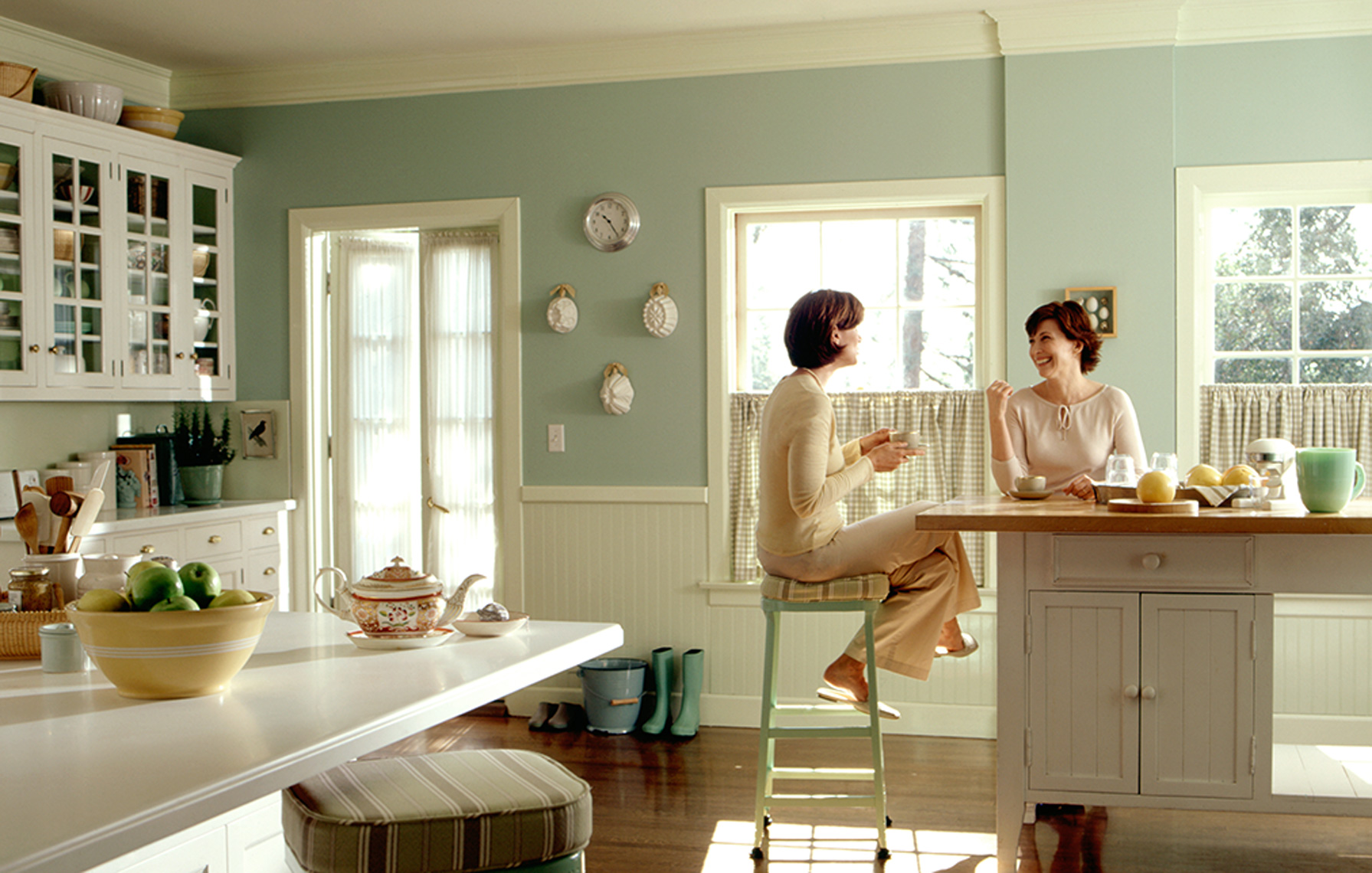women talking in kitchen